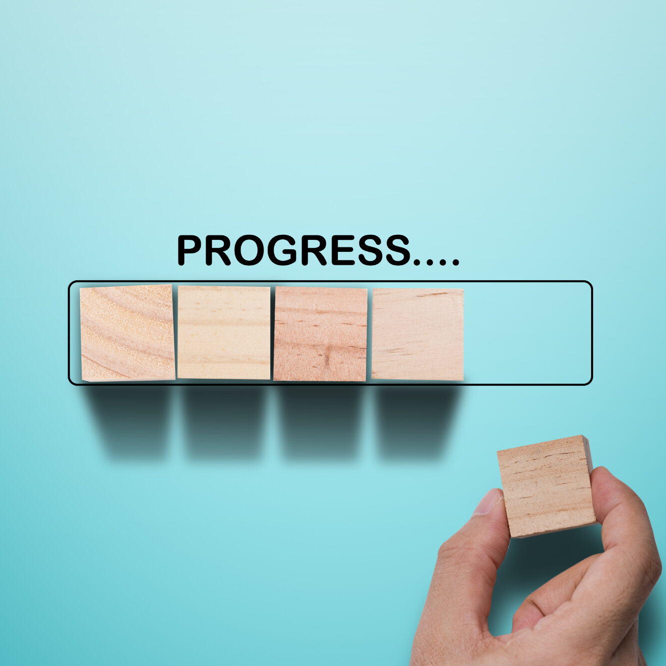 Hand putting wooden cube on virtual infographic rectangle block with progress wording. Job progressive concept.