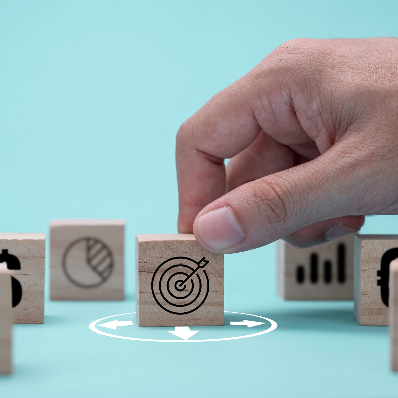 Hand putting target board with arrow on green background to setup objective target and investment goal.